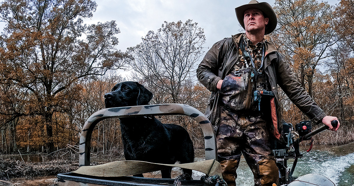 Waterfowl hunter driving boat. Photo by Ed Wall Media